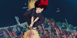 Best Studio Ghibli Movies for Autumn: Cozy, Rainy-Day and Golden-Hour Picks Kiki flying above a town in an official Studio Ghibli still, used for an autumn Ghibli movie guide