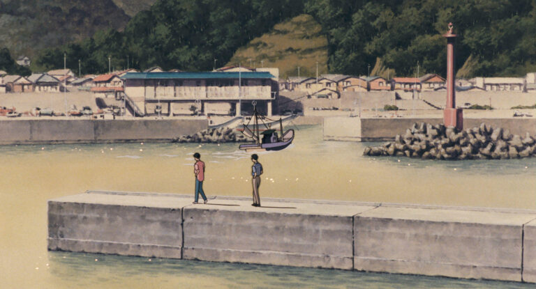 Two friends stand together by the water in Ocean Waves